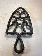 Vintage black, footed cast iron trivet. 7 x 3.5”