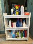 Slide-in laundry caddy and contents…..24-3/4 x 8-1/4 x 31-1/2 tall…..all contents are partial boxes and bottles