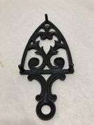 Vintage 1955 JZH Black Cast Iron Footed Trivet Cathedral T-12 R. 8.5 x 3.75”.