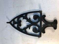 Vintage black, footed cast iron trivet. 8 x 3.75”