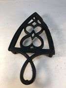 1800 to early 1900s cast iron footed trivet. 7.5 x 4”.