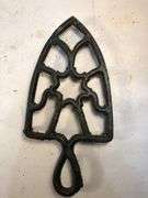 Vintage black, footed cast iron trivet. 7 x 3.5”
