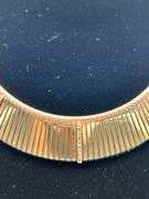 Gold tone choker with rows of clear stones…..clasp needs adjusted and tightened