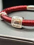 Elegant Brighton bangle with rhinestone Christmas tree charm and 2 red stone separators…..has magnetic closure and bag