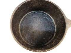 Antique "spider pot" with three legs and a gate mark.  2 7/8” h. 5” diameter. 6” L.