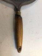 Antique stovetop heat diffuser, also known as a simmer plate or flame fanner with wooden handle, 14 L. 8 1/4” diameter.