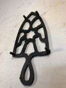 Vintage black, footed cast iron trivet. 7 x 3.5”