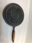 Antique stovetop heat diffuser, also known as a simmer plate or flame fanner with wooden handle, 14 L. 8 1/4” diameter.
