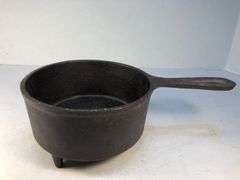 Antique "spider pot" with three legs and a gate mark.  2 7/8” h. 5” diameter. 6” L.