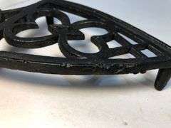 1800 to early 1900s cast iron footed trivet. 7.5 x 4”.