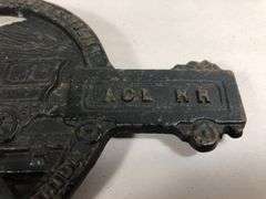 Vintage cast iron trivet featuring a steam locomotive and the text "ACL RR," which stands for the Atlantic Coast Line RR black trivet. VA Mertalcrafters #9-40   7 x 5 “