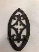 Antique child SAD iron footed trivet. Black. 3.5 x 2”