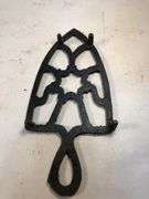 Vintage black, footed cast iron trivet. 7 x 3.5”