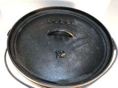 Lodge #12 12” 6 quart outdoor Dutch oven with flanged lid and integral legs. Stored in original box. Possibly new.