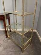 Gold-tone metal shelving unit with 4 glass shelves…..24-1/2 x 14-1/4 x 67-1/2 tall…..OTHER CONTENTS NOT INCLUDED