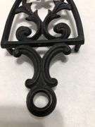Vintage 1955 JZH Black Cast Iron Footed Trivet Cathedral T-12 R. 8.5 x 3.75”.