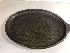 Lodge oval sizzle server #2. Surface area 9.5 x 7”. Not seasoned. No spin or wobble.
