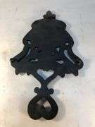 J.Z.H. 1948 cast iron Sunburst trivet. Black. Footed. 9 x 5”