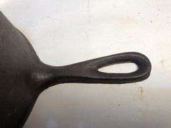 Antique "spider pot" with three legs and a gate mark.  2 7/8” h. 5” diameter. 6” L.