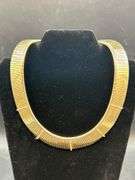 Gold tone choker with rows of clear stones…..clasp needs adjusted and tightened