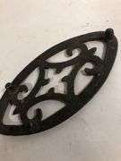 Antique child SAD iron footed trivet. Black. 3.5 x 2”