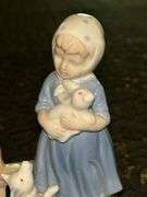 Vintage Porcelain Figurine of Girl in Blue Dress Holding White Bunny Rabbit with Dog by her side….5-3/4” tall….original label which reads by Lego