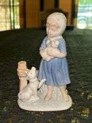 Vintage Porcelain Figurine of Girl in Blue Dress Holding White Bunny Rabbit with Dog by her side….5-3/4” tall….original label which reads by Lego