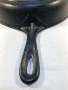 Vi tage cast iron skillet with heat ring. Raised 8 on the front of handle. Ridge on the back ending in a triagular shape in pan side. 0 on back. No spin, no wobble.