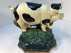 Vintage pair of cast iron black and white spotted pig book ends/door stops. 5 1/2” W x 5” H x 2”D.