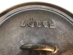 Lodge #12 12” 6 quart outdoor Dutch oven with flanged lid and integral legs. Stored in original box. Possibly new.