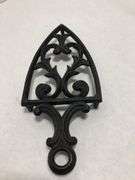 Vintage 1955 JZH Black Cast Iron Footed Trivet Cathedral T-12 R. 8.5 x 3.75”.