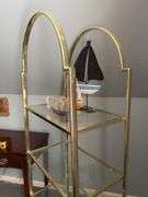 Gold-tone metal shelving unit with 4 glass shelves…..24-1/2 x 14-1/4 x 67-1/2 tall…..OTHER CONTENTS NOT INCLUDED
