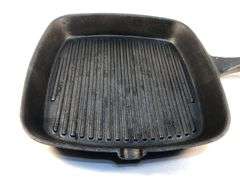 Internationals black cast iron 9” square ribbed griddle pan with pour spout. 1 1/4” D. No spin, no wobble.