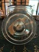 Clear glass candy/apothecary jar with lid and wooden scoop….6-5/8” D x 10” tall