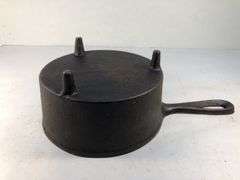 Antique "spider pot" with three legs and a gate mark.  2 7/8” h. 5” diameter. 6” L.