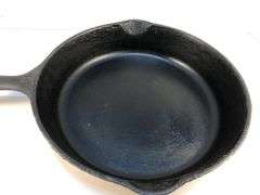 Unmarked #8  10” diameter 2 spout skillet. No spin, no wobble.