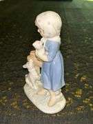 Vintage Porcelain Figurine of Girl in Blue Dress Holding White Bunny Rabbit with Dog by her side….5-3/4” tall….original label which reads by Lego