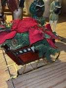 Beautiful grouping of Christmas decor…..box of greenery and ribbon, hammered metal deer, (4) great looking ceramic carolers and sleigh with artificial poinsettias