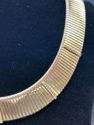 Gold tone choker with rows of clear stones…..clasp needs adjusted and tightened