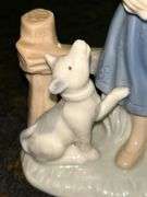 Vintage Porcelain Figurine of Girl in Blue Dress Holding White Bunny Rabbit with Dog by her side….5-3/4” tall….original label which reads by Lego