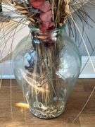 Clear glass urn with artificials…..approx. 46” tall including artificials