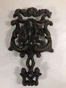 Vintage Wilton cast iron Cherub trivet. Black. 8 x 4.5”.