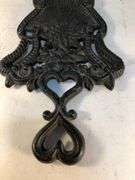 J.Z.H. 1948 cast iron Sunburst trivet. Black. Footed. 9 x 5”