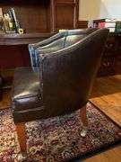 Barrel back leather office chair on casters…..sows wear from normal use but lots of life left…..sits and rolls very well….25 x 18 x 29-3/4 tall overall