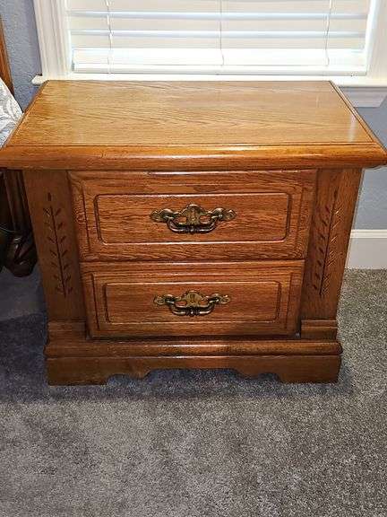 Two drawer oak finish nightstand.