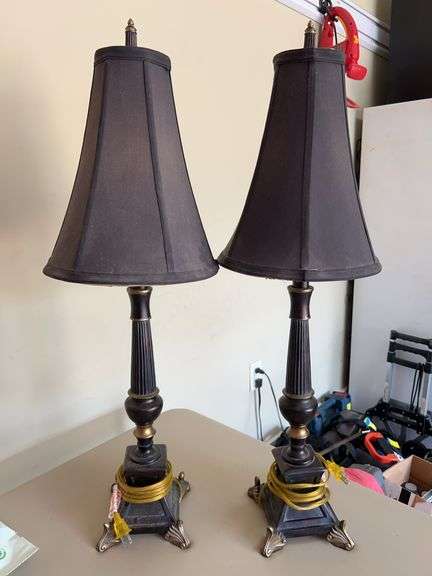Pair of black and gold resin base candlestick lamps with black cloth shades…..they do need a good wipe down from being in the attic…..30” tall image