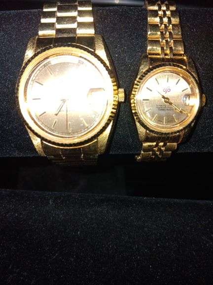 Mens and ladies gold watches image