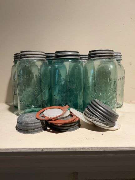 Grouping of (7) green Genuine Boyds Quart Mason jars with zinc lids……also includes extra lids image