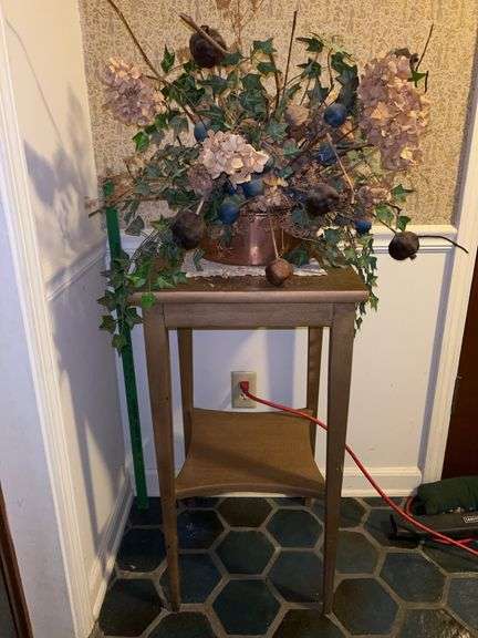 Wooden plant stand with copper planter with artificials image