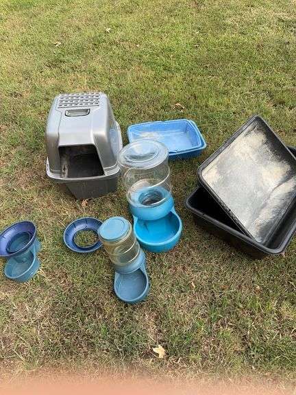 Grouping of cat litter and water containers.